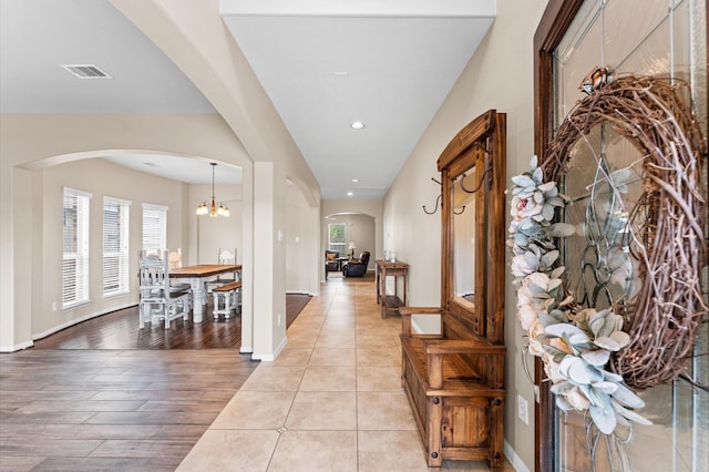 406 Oak Stream Dr, Conroe, TX 77304 - foyer entrance featuring arched walkways, plenty of natural light, a chandelier, baseboards, and recessed lighting