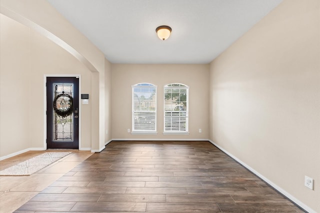 406 Oak Stream Dr, Conroe, TX 77304 - foyer entrance with dark wood-type flooring, arched walkways, and baseboards