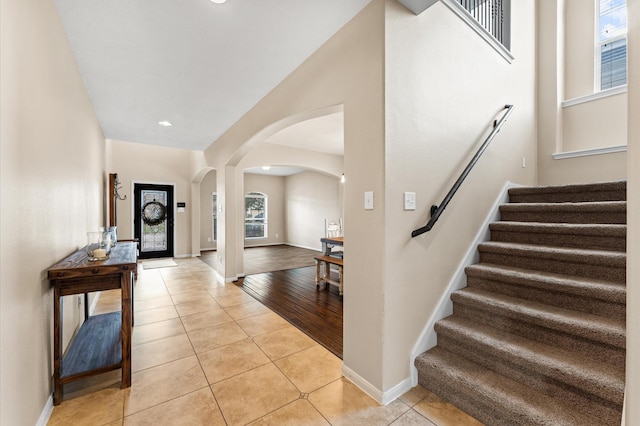 406 Oak Stream Dr, Conroe, TX 77304 - entrance foyer featuring arched walkways, stairs, light tile patterned floors, baseboards, and recessed lighting