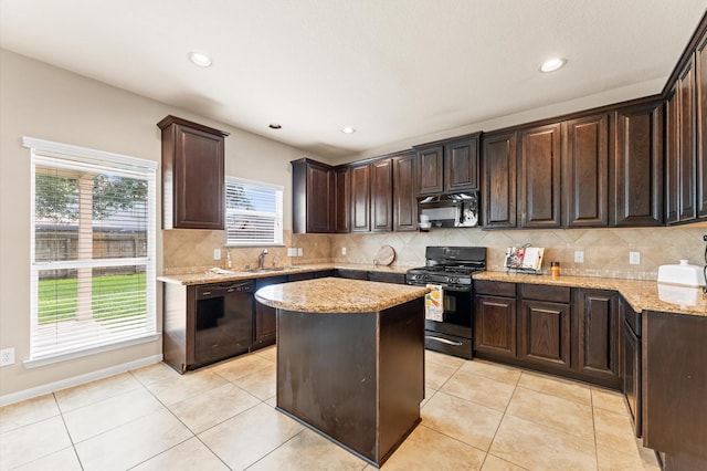 406 Oak Stream Dr, Conroe, TX 77304 - kitchen featuring black appliances, dark brown cabinets, tasteful backsplash, light stone counters, and recessed lighting