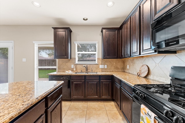 406 Oak Stream Dr, Conroe, TX 77304 - kitchen with black appliances, a sink, light stone counters, decorative backsplash, and recessed lighting