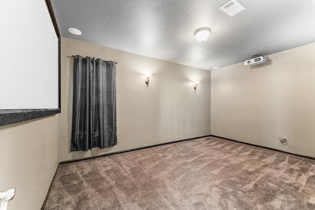 406 Oak Stream Dr, Conroe, TX 77304 - cinema room featuring carpet floors, baseboards, and a textured ceiling