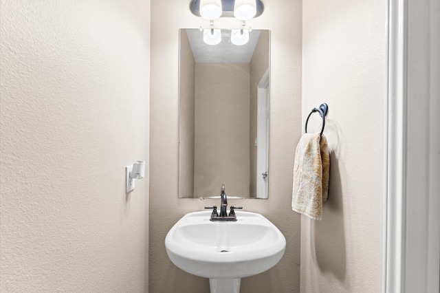 406 Oak Stream Dr, Conroe, TX 77304 - bathroom featuring a sink and a textured wall