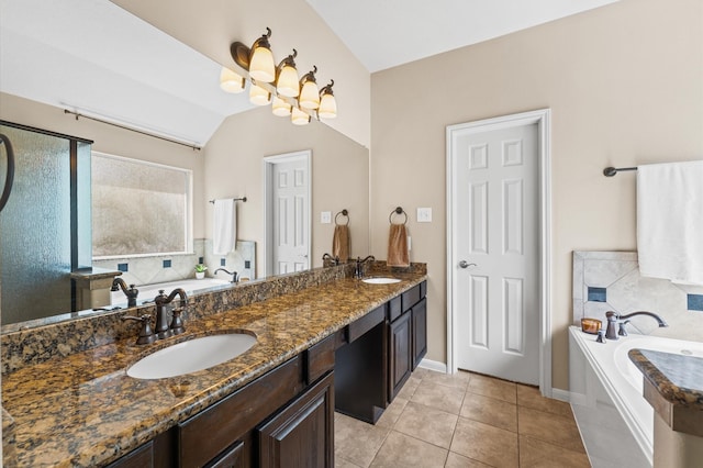 406 Oak Stream Dr, Conroe, TX 77304 - bathroom featuring a garden tub, double vanity, vaulted ceiling, tile patterned floors, and baseboards