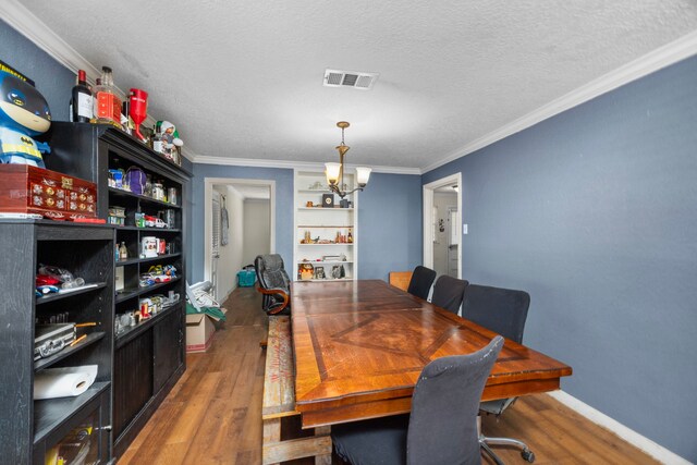 917 Alvin St, Pasadena, TX 77506 - dining room featuring a chandelier, wood finished floors, crown molding, a textured ceiling, and baseboards