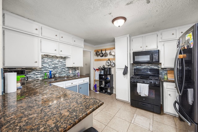 917 Alvin St, Pasadena, TX 77506 - kitchen featuring black appliances, backsplash, white cabinets, light tile patterned floors, and a sink