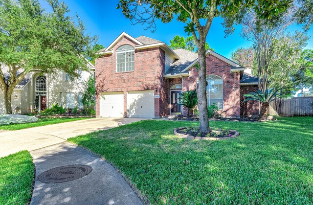 24034 River Place Dr, Katy, TX 77494 - traditional-style house featuring brick siding, concrete driveway, a garage, and a shingled roof
