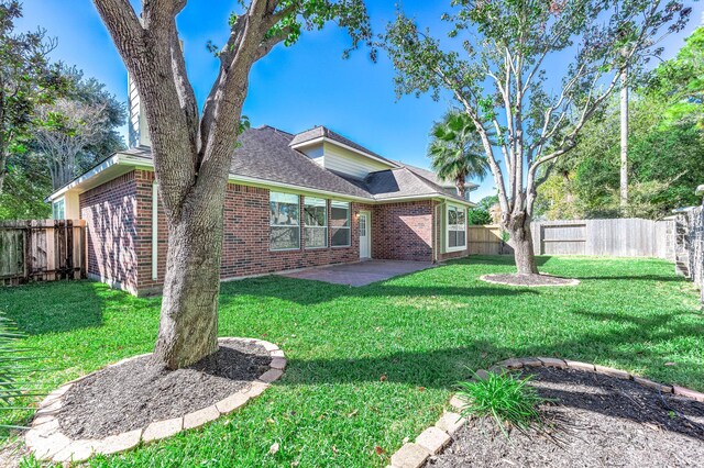 24034 River Place Dr, Katy, TX 77494 - back of house featuring brick siding, a patio, and a shingled roof