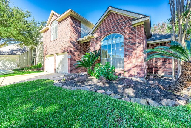 24034 River Place Dr, Katy, TX 77494 - traditional-style home with brick siding, driveway, a front lawn, and an attached garage