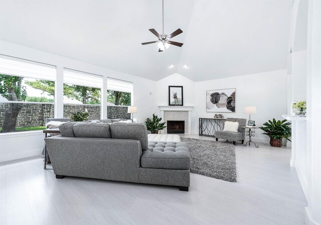 24034 River Place Dr, Katy, TX 77494 - living room featuring ceiling fan, wood finished floors, baseboards, a tile fireplace, and high vaulted ceiling