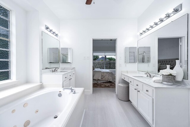 24034 River Place Dr, Katy, TX 77494 - full bathroom with ensuite bathroom, wood finished floors, vanity, and a tub with jets