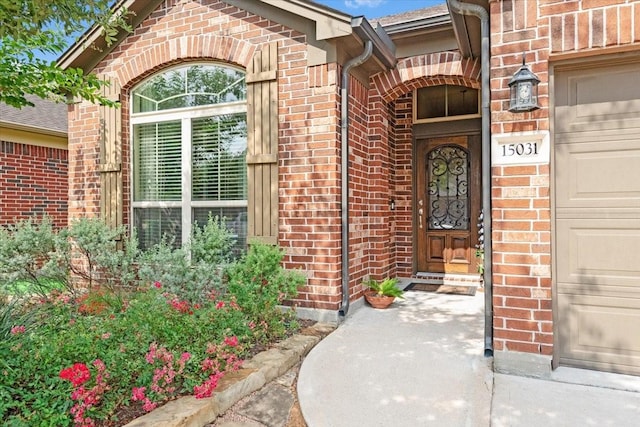 15031 Appian Oak St, Cypress, TX 77429 - view of exterior entry with brick siding and an attached garage