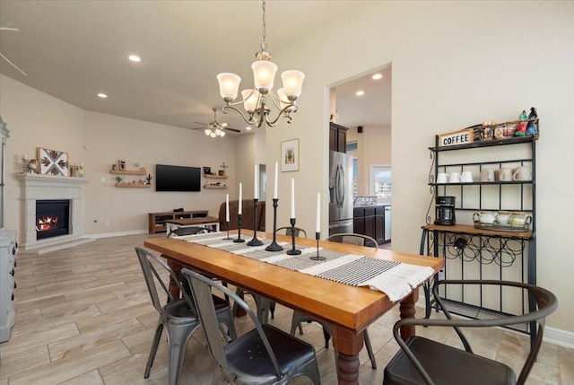15031 Appian Oak St, Cypress, TX 77429 - dining space with a ceiling fan, a chandelier, recessed lighting, a warm lit fireplace, and baseboards