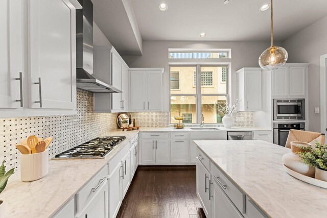 111 E 2nd St, Houston, TX 77007 - kitchen with wall chimney range hood, appliances with stainless steel finishes, a sink, white cabinets, and recessed lighting