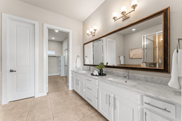 111 E 2nd St, Houston, TX 77007 - bathroom with double vanity, tile patterned flooring, a closet, a stall shower, and baseboards