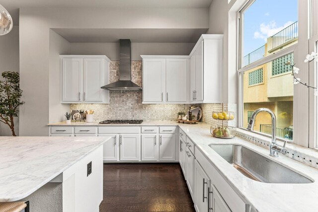 111 E 2nd St, Houston, TX 77007 - kitchen with wall chimney exhaust hood, a sink, gas stovetop, white cabinetry, and tasteful backsplash