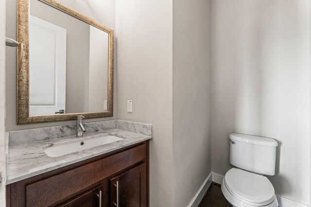 111 E 2nd St, Houston, TX 77007 - half bathroom with toilet, vanity, and baseboards