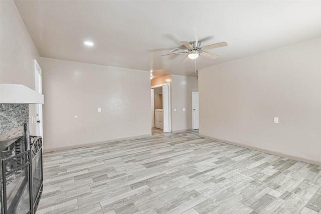 16538 Park Scot Dr, Houston, TX 77084 - unfurnished living room with a fireplace, a ceiling fan, light wood-style flooring, baseboards, and recessed lighting