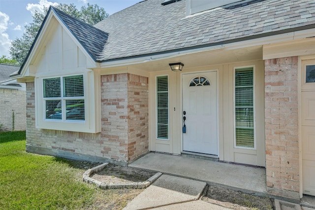 16538 Park Scot Dr, Houston, TX 77084 - view of exterior entry featuring a shingled roof and brick siding