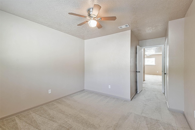 16538 Park Scot Dr, Houston, TX 77084 - spare room featuring light colored carpet, a textured ceiling, a ceiling fan, and baseboards