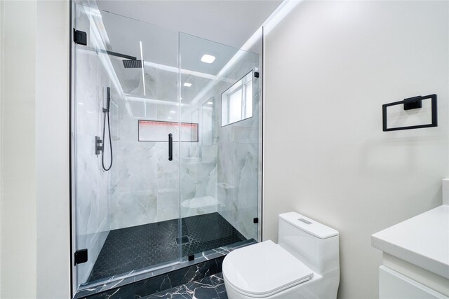 16538 Park Scot Dr, Houston, TX 77084 - bathroom featuring toilet, vanity, marble look tile flooring, and a marble finish shower