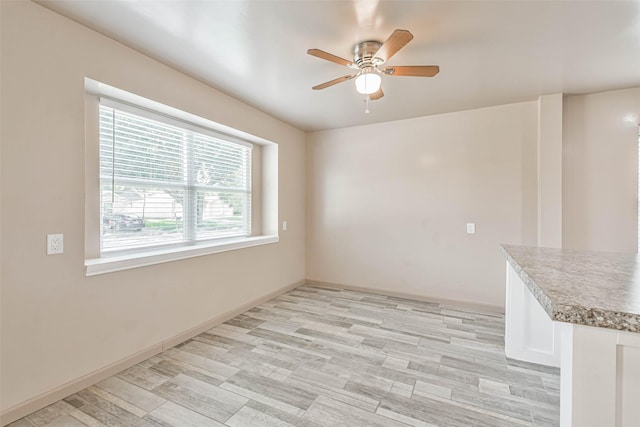 16538 Park Scot Dr, Houston, TX 77084 - unfurnished dining area with a ceiling fan, light wood-style floors, and baseboards