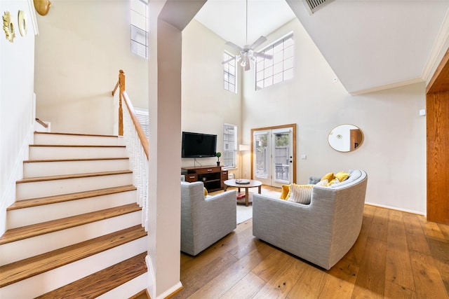 1538 Bevis St, Houston, TX 77008 - living area with a ceiling fan, hardwood / wood-style floors, stairs, and a towering ceiling