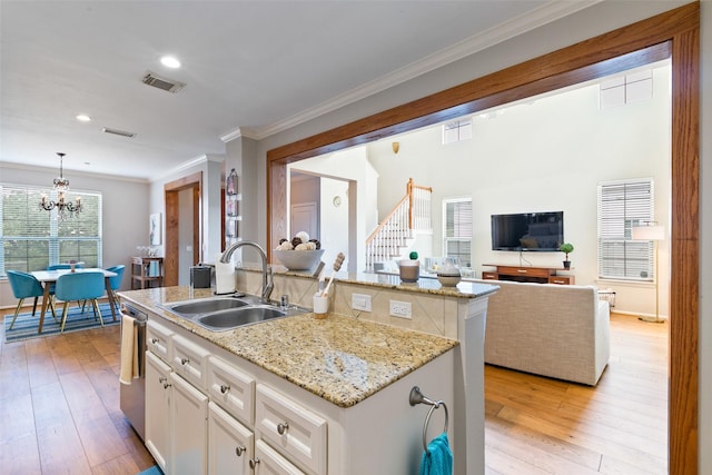 1538 Bevis St, Houston, TX 77008 - kitchen with a sink, a chandelier, open floor plan, dishwasher, and white cabinets
