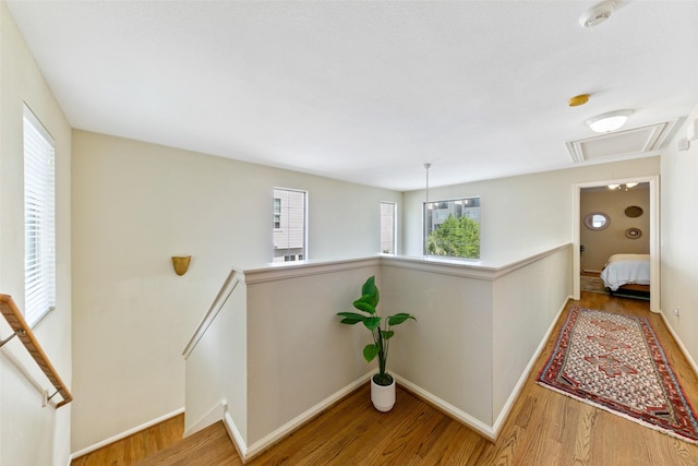 1538 Bevis St, Houston, TX 77008 - corridor featuring an upstairs landing, wood finished floors, attic access, and baseboards