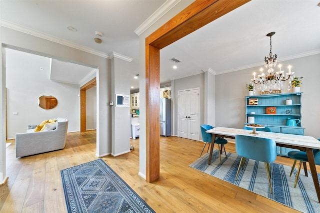 1538 Bevis St, Houston, TX 77008 - dining room featuring light wood-style floors, ornamental molding, a chandelier, and baseboards