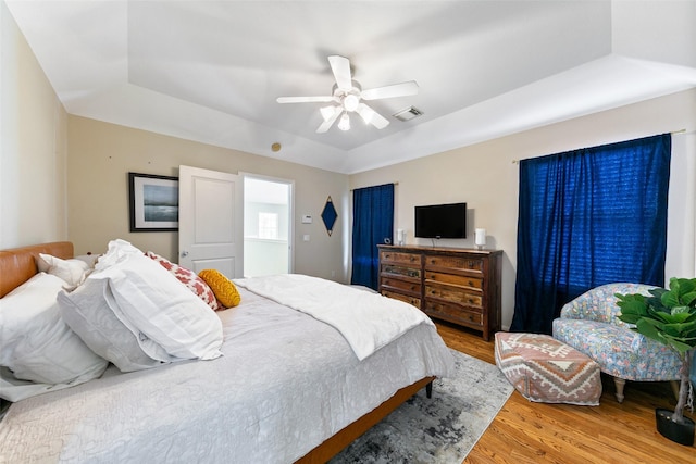 1538 Bevis St, Houston, TX 77008 - bedroom with wood finished floors, a raised ceiling, and a ceiling fan