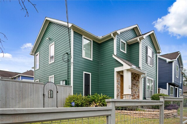 1538 Bevis St, Houston, TX 77008 - view of front of house featuring a gate and stone siding