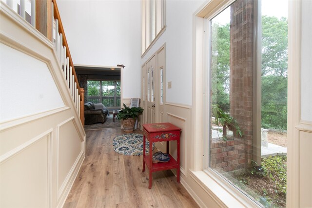 901 Hartrick Canyon Dr, Temple, TX 76502 - foyer featuring wood finished floors, a decorative wall, stairway, and a wainscoted wall