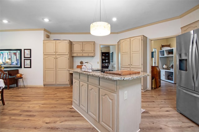 901 Hartrick Canyon Dr, Temple, TX 76502 - kitchen with stainless steel fridge with ice dispenser, a center island, ornamental molding, light stone counters, and light wood-style flooring