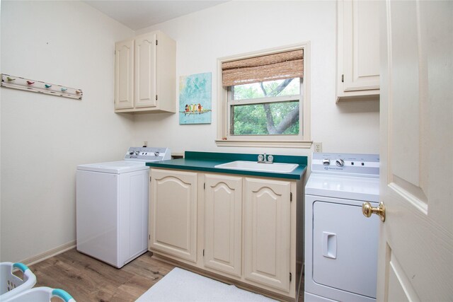 901 Hartrick Canyon Dr, Temple, TX 76502 - laundry room with washing machine and dryer, cabinet space, and light wood-style floors