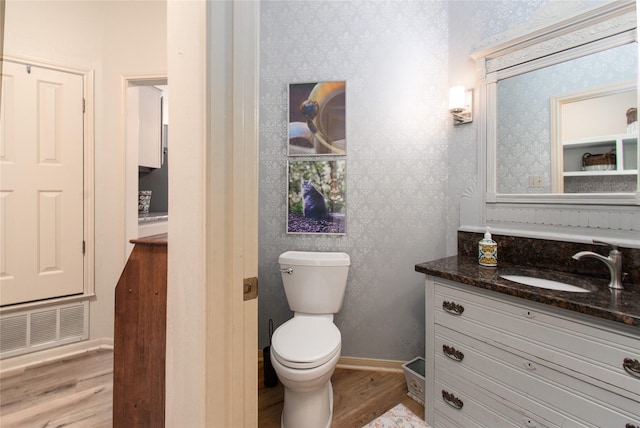 901 Hartrick Canyon Dr, Temple, TX 76502 - half bathroom with wallpapered walls, wood finished floors, vanity, toilet, and baseboards