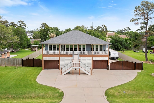 610 S Shady Ln, Shoreacres, TX 77571 - view of front facade with a gate, stairs, driveway, and a shingled roof