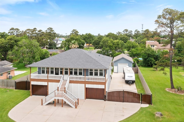 610 S Shady Ln, Shoreacres, TX 77571 - view of front of house featuring a gate, stairs, a shingled roof, a garage, and view of scattered trees