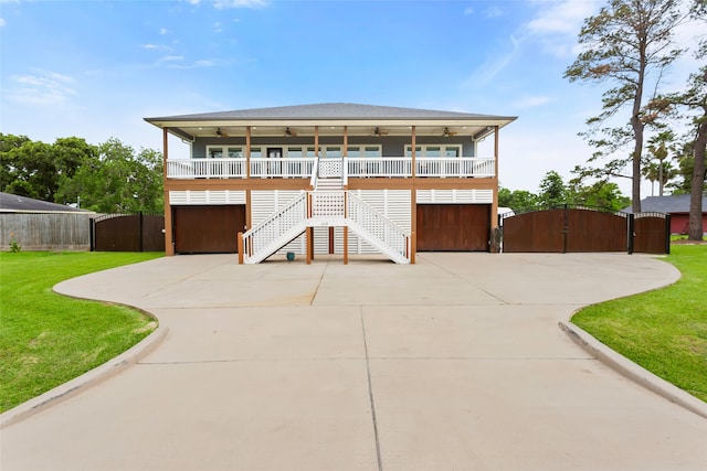 610 S Shady Ln, Shoreacres, TX 77571 - view of front of property featuring a gate, a ceiling fan, a porch, stairs, and driveway