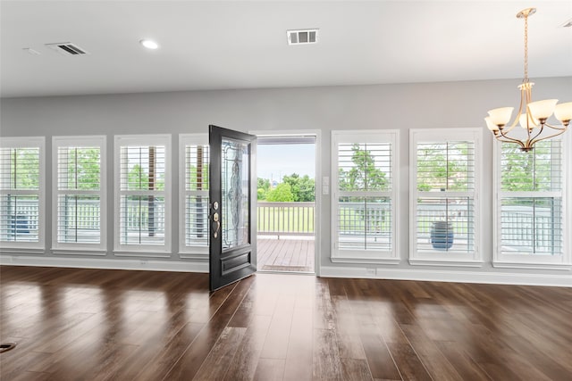 610 S Shady Ln, Shoreacres, TX 77571 - unfurnished dining area featuring a chandelier and dark wood finished floors