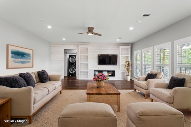 610 S Shady Ln, Shoreacres, TX 77571 - living area featuring stacked washer / drying machine, recessed lighting, light wood-style floors, a ceiling fan, and a glass covered fireplace