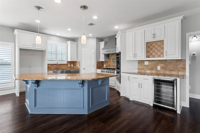 610 S Shady Ln, Shoreacres, TX 77571 - kitchen with wine cooler, custom exhaust hood, a sink, white cabinets, and dark wood-style floors