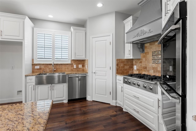 610 S Shady Ln, Shoreacres, TX 77571 - kitchen featuring appliances with stainless steel finishes, a sink, white cabinetry, light stone countertops, and recessed lighting