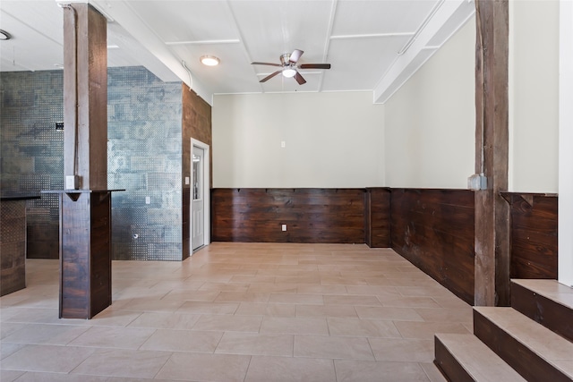 610 S Shady Ln, Shoreacres, TX 77571 - tiled empty room with a ceiling fan, a wainscoted wall, and wood walls