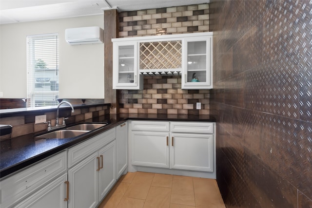 610 S Shady Ln, Shoreacres, TX 77571 - kitchen with a wall unit AC, a sink, light tile patterned floors, and dark countertops
