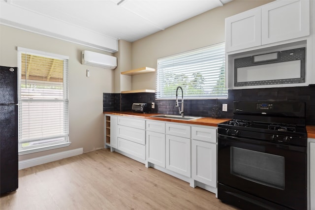 610 S Shady Ln, Shoreacres, TX 77571 - kitchen featuring black appliances, a sink, butcher block countertops, tasteful backsplash, and light wood-type flooring