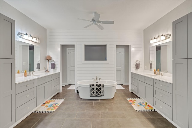 27326 S Karaugh Dr, Richmond, TX 77406 - bathroom featuring ceiling fan, two vanities, tile patterned flooring, and a soaking tub
