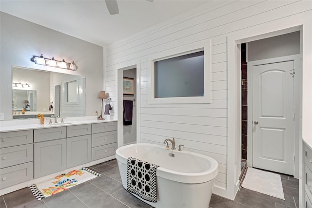 27326 S Karaugh Dr, Richmond, TX 77406 - full bath with vanity, tile patterned flooring, a freestanding tub, wood walls, and ceiling fan