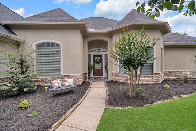 27326 S Karaugh Dr, Richmond, TX 77406 - view of exterior entry featuring stone siding, stucco siding, and a shingled roof
