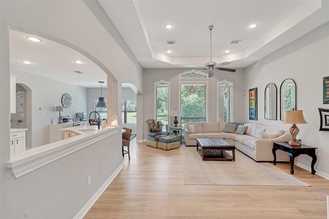27326 S Karaugh Dr, Richmond, TX 77406 - living area featuring arched walkways, ceiling fan, light wood finished floors, baseboards, and recessed lighting